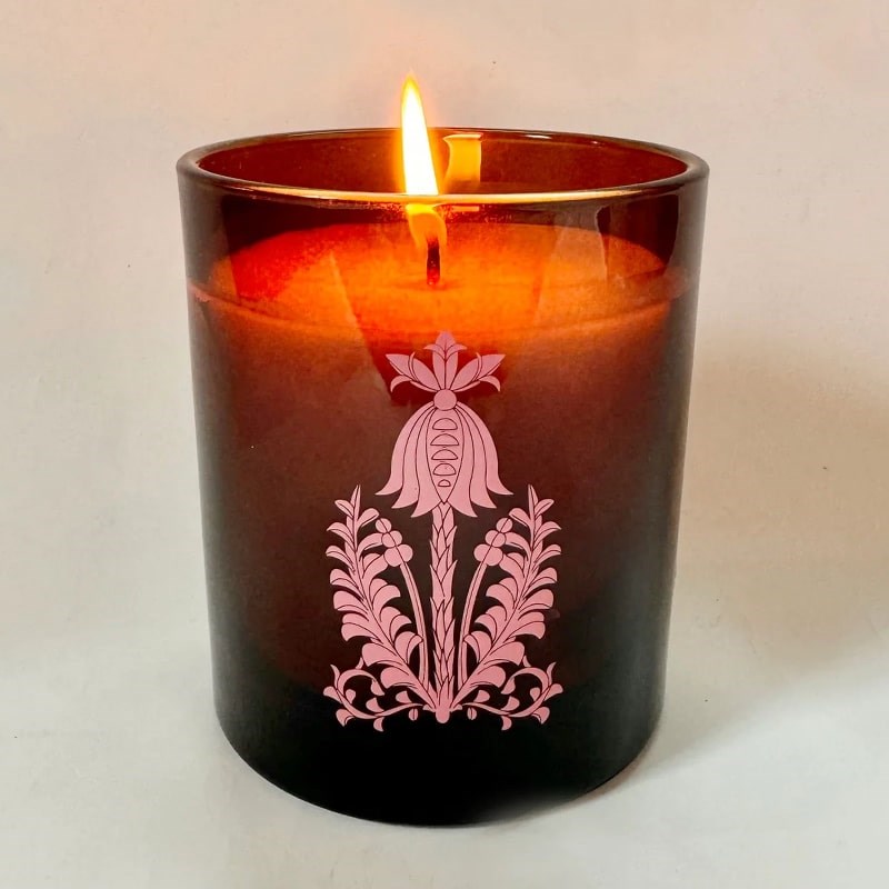 The Quiet Botanist Orchard Sun Scented Candle - product shown with lit wick