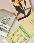 The Quiet Botanist Orchard Sun Scented Candle - product matchbooks shown open and closed