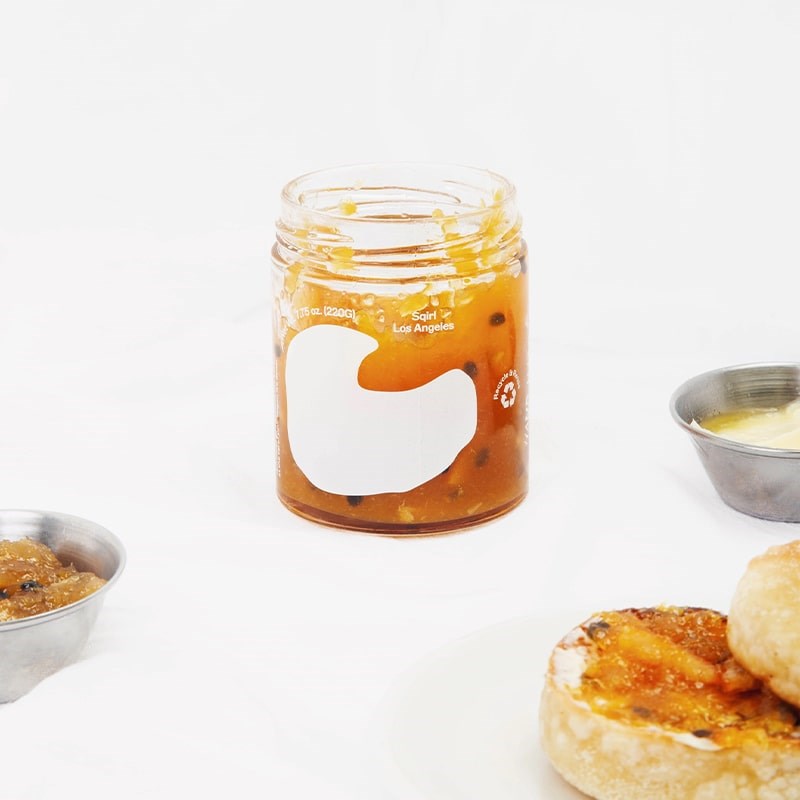 Sqirl Yuzu Passionfruit Fruit Spread - product shown without lid next to toast and butter