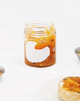 Sqirl Yuzu Passionfruit Fruit Spread - product shown without lid next to toast and butter