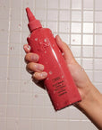 Oribe Bright Blonde Radiance & Repair Treatment - model holding product in shower