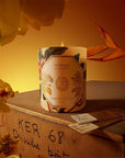 Carriere Freres Frangipani Candle - product shown on wooden box surrounded by flowers