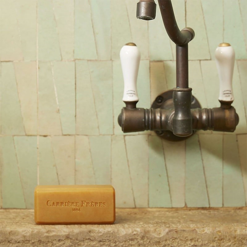 Carriere Freres Solid Body Soap - Silvae - product shown on stone sink with faucet  