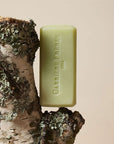 Carriere Freres Solid Body Soap - Bosci - product shown on wood piece with moss