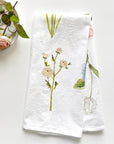 Emily Lex Studio Garden Flowers Tea Towel - product shown folded next to dish with flower on it