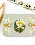 Firefly Notes Moth and Lotus Flower Storage Tin - Large - product shown next to measuring tape and sewing needles