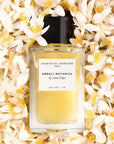 Lifestyle shot top view of Essential Parfums Neroli Botanica By Anne Flipo (100 ml) with Neroli flowers in the background