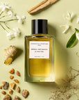 Lifestyle shot top view of Essential Parfums Neroli Botanica By Anne Flipo (100 ml) with neroli, ginger and other ingredients in the background