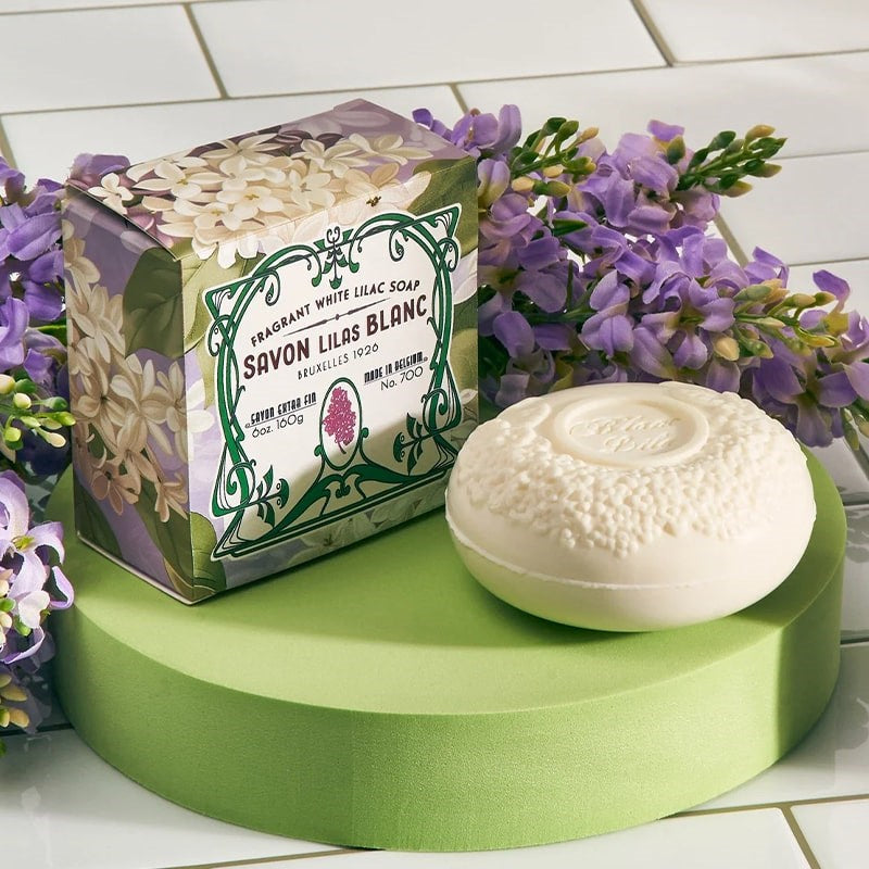 Lifestyle shot of Blanc Lila Lilac Soap (6 oz) with box and lilacs in the background