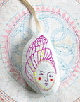 Skippy Cotton Little Shell Person - Lavender Scented Token - product shown on top of fabric 