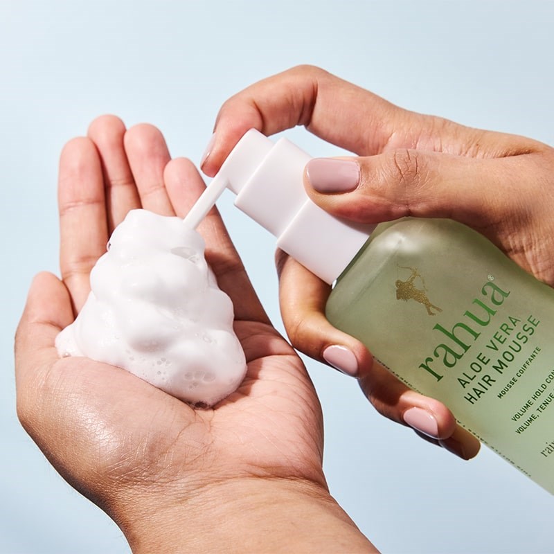 Rahua Aloe Vera Hair Mousse - model shown dispensing product into hand