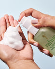 Rahua Aloe Vera Hair Mousse - model shown dispensing product into hand