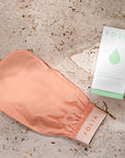 Folia Body Exfoliating Body Mitt - product shown on stone