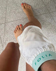 Folia Body Exfoliating Tan Removal Mitt - model shown using product on leg