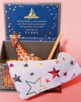 Camp Hollow Giraffe Cake Topper - product shown next to included candle and bag inside packaging