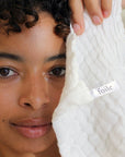 Foile Face Cloth - model shown holding product close to face