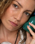 Foile Skin Sponge Serum - model shown holding product next to face