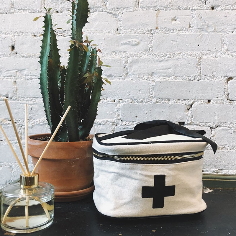 Bag-All Meds and First Aid Storage Box - Cream - product shown on table with plant  and diffuser