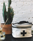 Bag-All Meds and First Aid Storage Box - Cream - product shown on table with plant  and diffuser