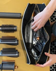 Bag-All Roomy Hair Wrap Tools Travel Case - Black - model shown placing hair accessories inside product