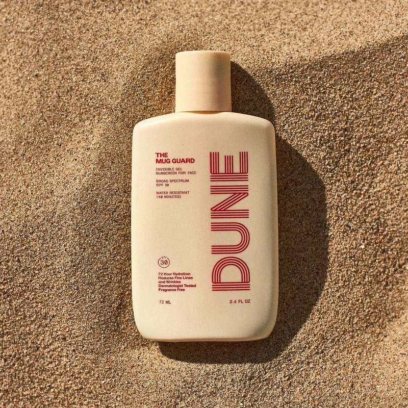 DUNE Suncare The Mug Guard - product shown on sand