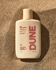 DUNE Suncare The Mug Guard - product shown on sand