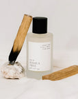 Orchid + Ash Joshua Tree Ritual Spray - product shown next to palo santo sticks and rock