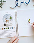 Emily Lex Studio Winter Watercolor Workbook - model shown painting inside product