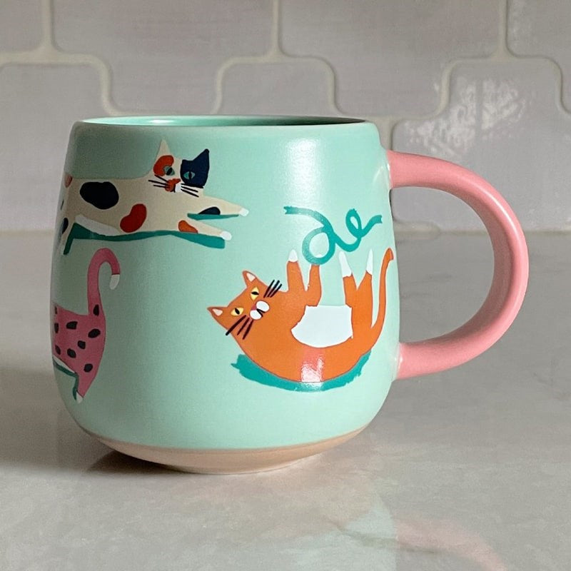 Idlewild Co Cats Ceramic Mug - product shown on countertop 