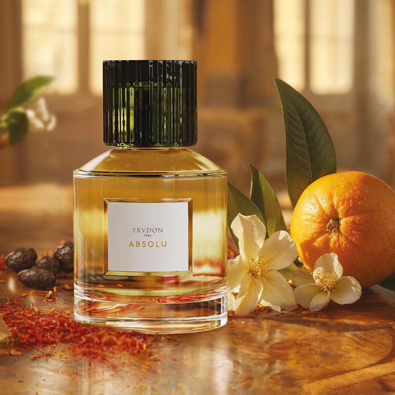 Trudon Absolu Eau de Parfum - product shown next to fragrance ingredients on table