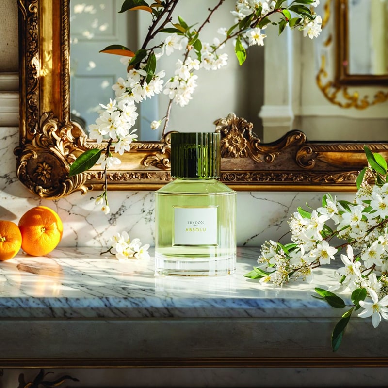 Trudon Absolu Eau de Parfum - product shown on table next to plants and oranges