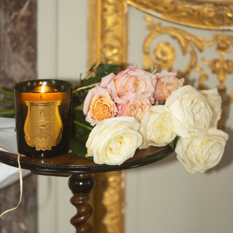 Trudon Tuileries Candle - product shown on table with flowers