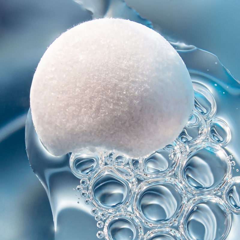 Close up of Snow Fox Skincare Ceramide & EGF Treatment Orb - with water