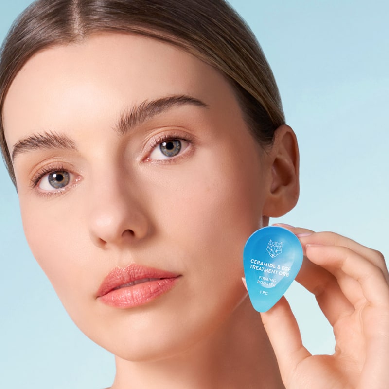 Model holding Snow Fox Skincare Ceramide &amp; EGF Treatment Orb (1 pc)