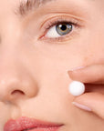 Close up of model shown holding Snow Fox Skincare Ceramide & EGF Treatment Orb (1 pc)