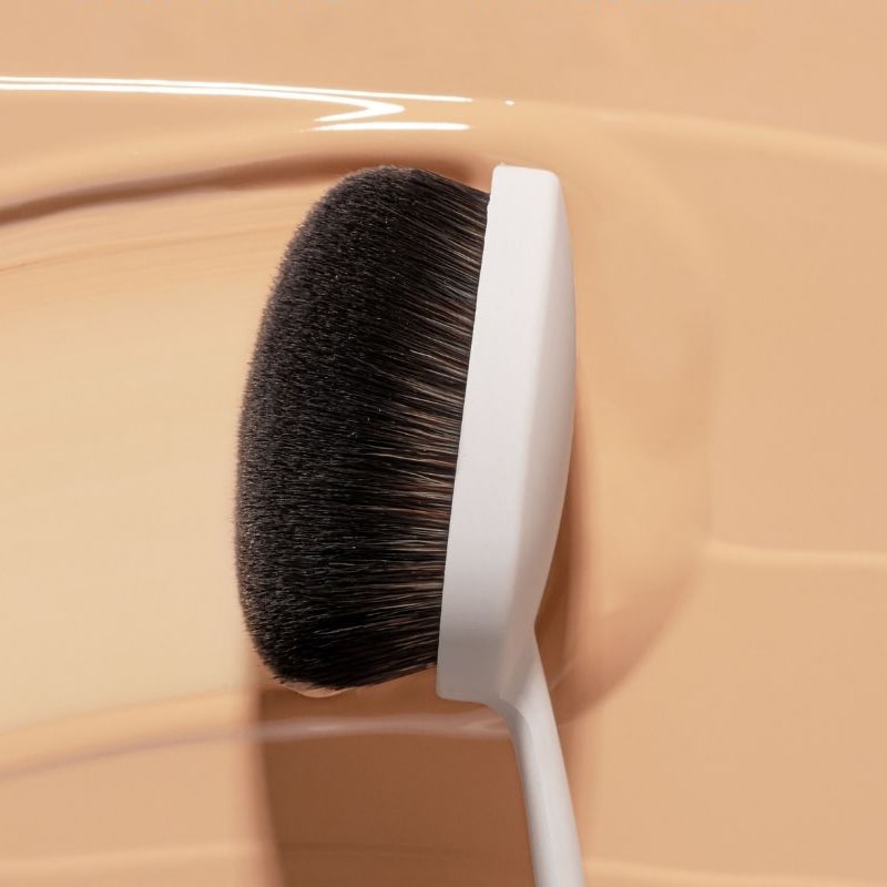 Snow Fox Skincare Instant Cloud Skin Smoothing Brush - product shown on top of makeup