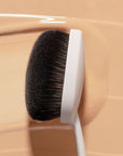 Snow Fox Skincare Instant Cloud Skin Smoothing Brush - product shown on top of makeup