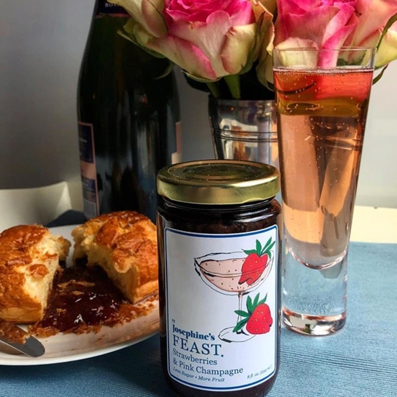 Josephine's Feast Strawberry & Pink Champagne Preserves - product shown next to pasties, champagne, and flowers