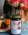 Josephine's Feast Strawberry & Pink Champagne Preserves - product shown next to pasties, champagne, and flowers