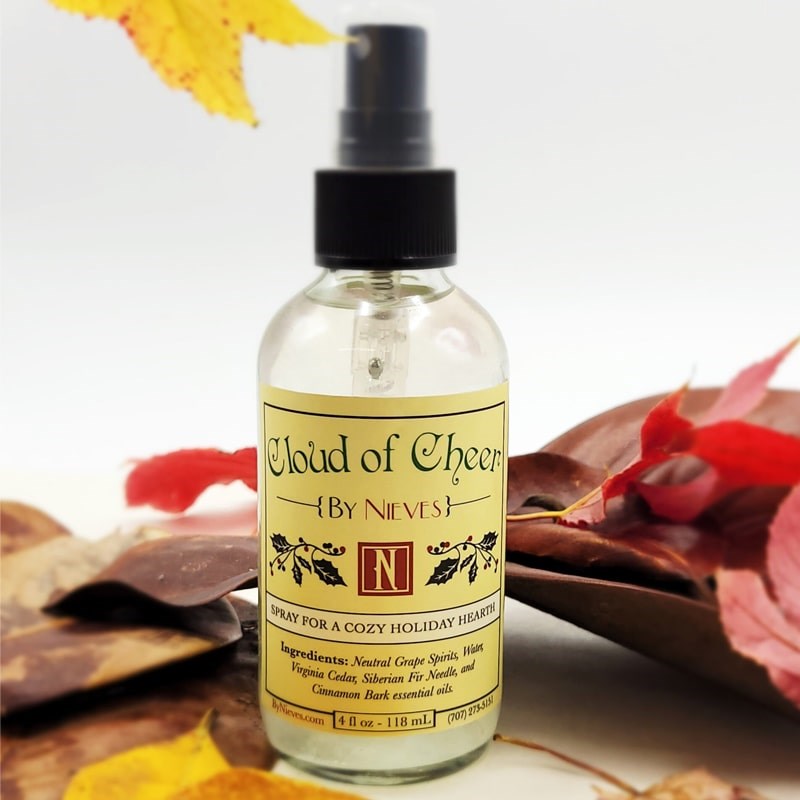 Lifestyle shot of By Nieves Cloud of Cheer (4 oz) with fall leaves in the background