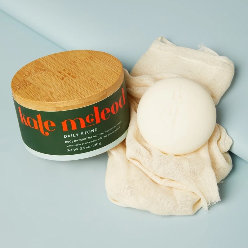 Kate McLeod Daily Stone Deep Moisturizing Lotion Bar - product shown next to packaging and cloth