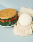 Kate McLeod Daily Stone Deep Moisturizing Lotion Bar - product shown next to packaging and cloth