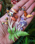 Model holding Moth & Myth Ferns & Friends Psychedelic Mini Set (7 pcs) in palm of hand