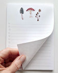 Emily Lex Studio Mushroom Checklist Notepad - model shown folding page of product