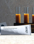 Moko Manuka Wound Ointment - product shown in front of product ointment in glass