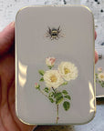 Firefly Notes Bee And Rose Tin - Large - model shown holding product