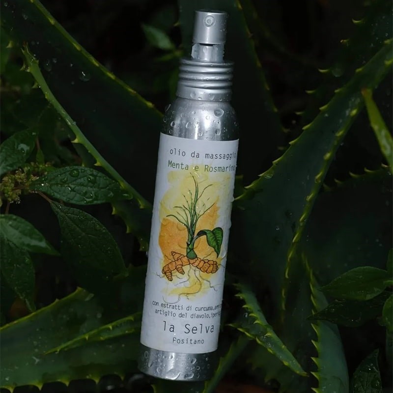 La Selva Positano Mint and Rosemary Massage Oil - product shown on top of plants