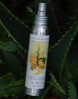 La Selva Positano Mint and Rosemary Massage Oil - product shown on top of plants