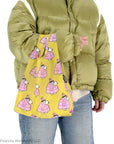 Close up of model holding Baggu Baby Baggu - Puffer Snoopy Pink (1 pc)