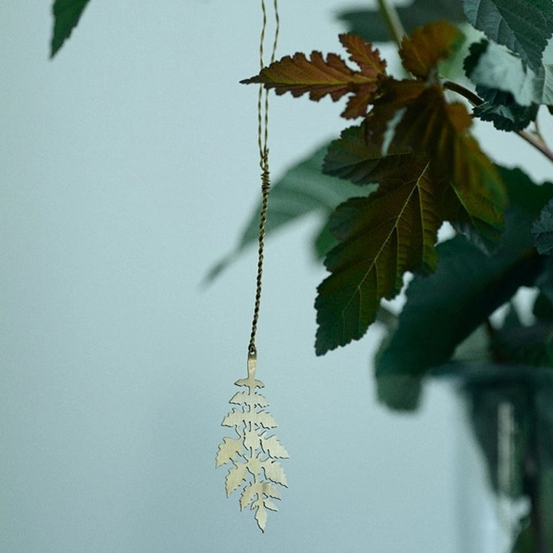 Fog Linen Work Brass Leaf - K - product shown hanging from plant